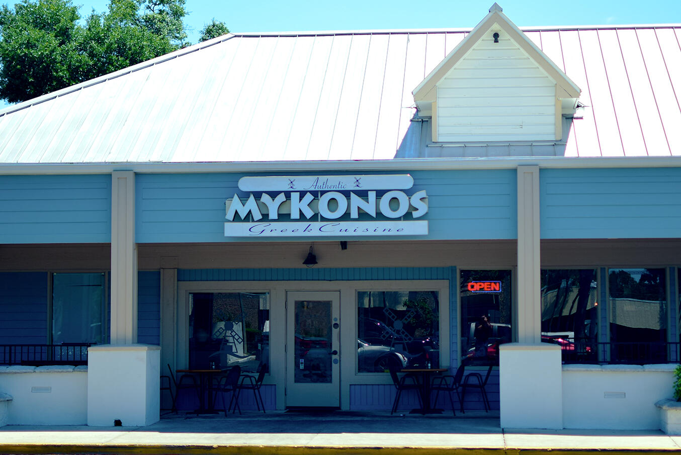 Photo of Mykonos Authentic Greek Cuisine in Longwood, FL from the outside showing the sign and outdoor seating