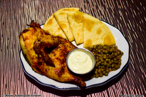half roasted chicken, our amazing green peas, and pita bread